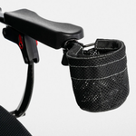 Black mesh cup holder attached beside a Jazzy Carbon power chair armrest