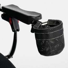 Black mesh cup holder attached beside a Jazzy Carbon power chair armrest
