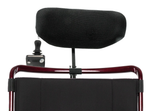 Black headrest and attendant joystick control mounted behind a red wheelchair backrest