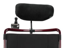 Black headrest and attendant joystick control mounted behind a red wheelchair backrest