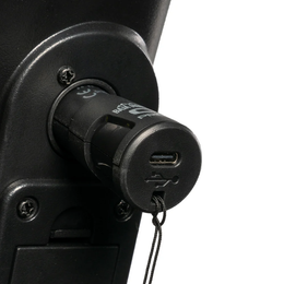 Black XLR USB-C charger plugged into a mobility device port, showing the USB-C socket and tethered cap