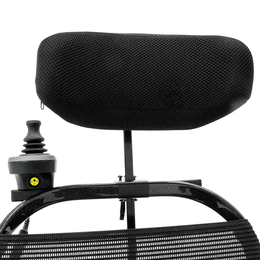 Jazzy Ultra Light attendant joystick control and black headrest mounted behind the wheelchair backrest